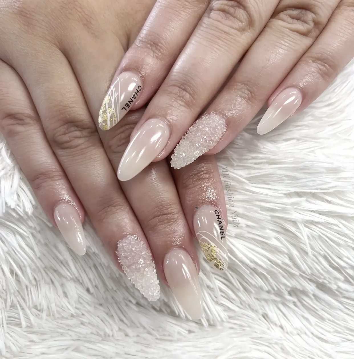 Soft nude almond nails with sugar crystal texture and gold line art